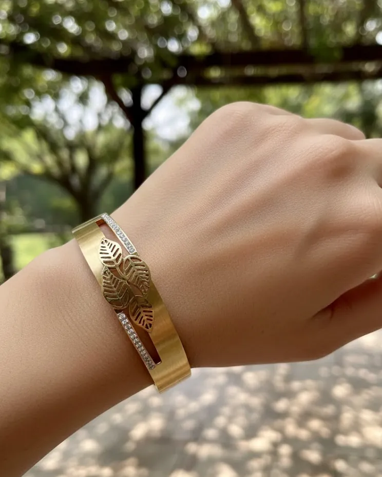 Gold bangle worn on the wrist